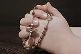 hands praying during the rosary