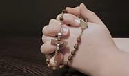 hands praying during the rosary